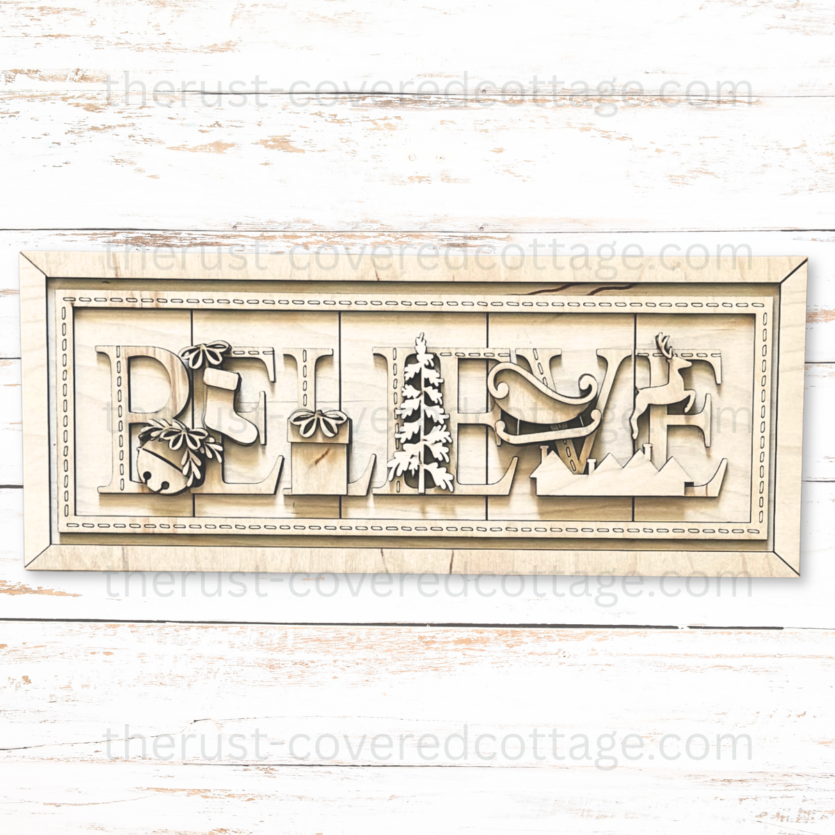 Unfinished Believe Stitched Sign wood kit with BELIEVE letters, bell, stocking, gift, tree, sleigh, reindeer, rooftops, and decorative stitch details.