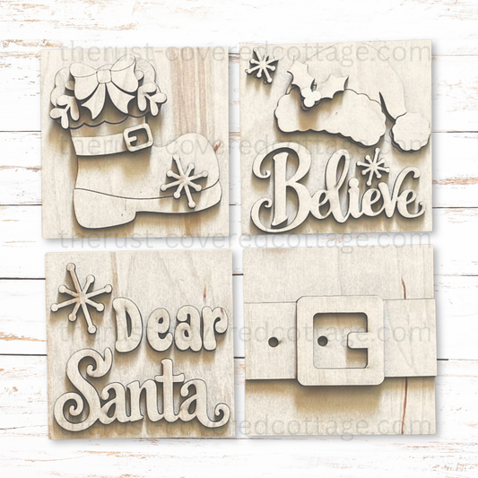 Four unfinished Dear Santa mini wood signs featuring a Santa boot, Believe with a Santa hat, Dear Santa lettering, and a Santa belt buckle.