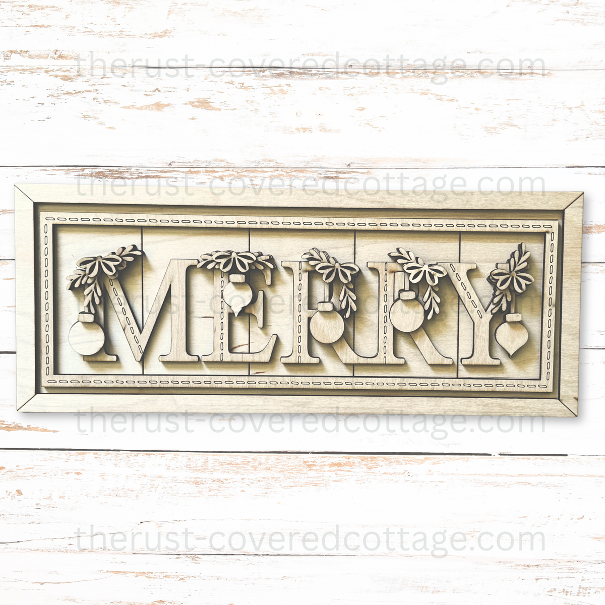 Unfinished Merry Stitched Sign wood kit with MERRY letters, hanging ornaments, bows, leafy sprigs, and decorative stitch details on the letters and border.