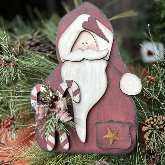 Finished Primitive Santa styled with greenery and a star accent