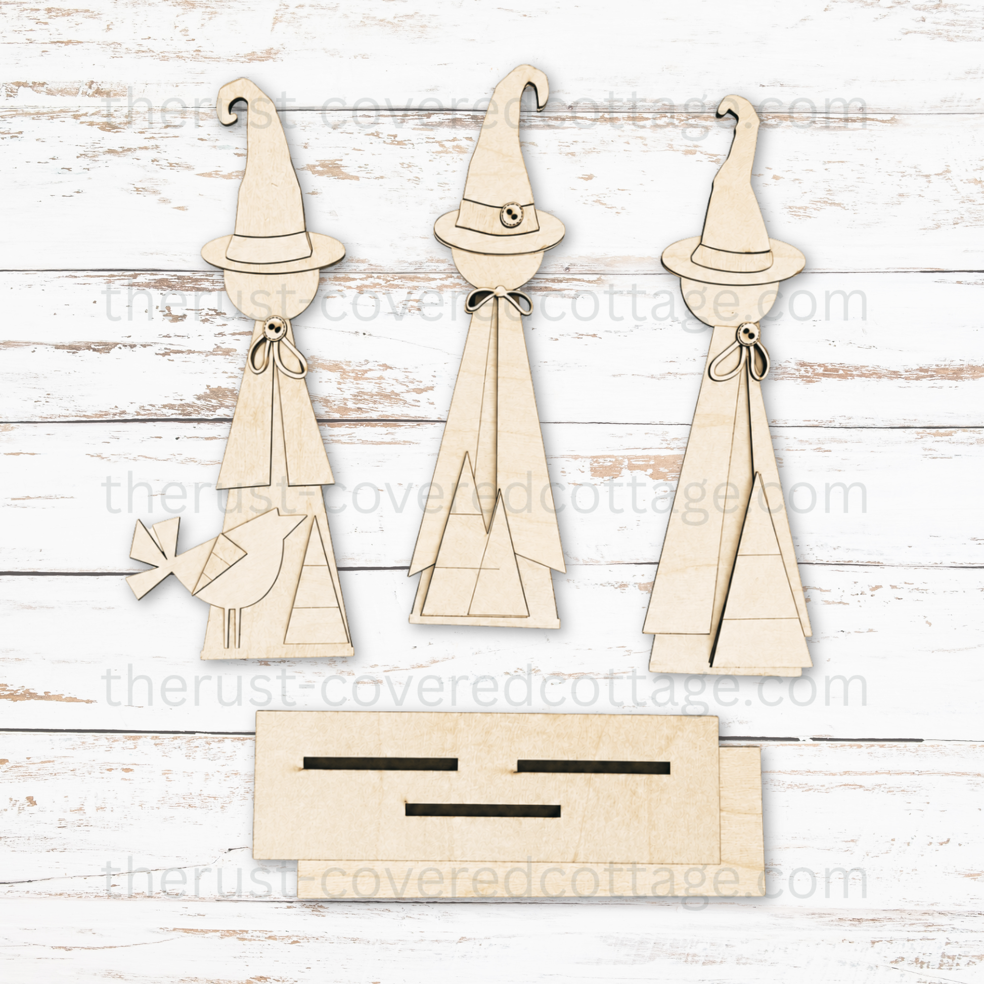 Unfinished Witch Trio multi-layered DIY wood kit featuring three standing witches, a bird accent and slotted display base